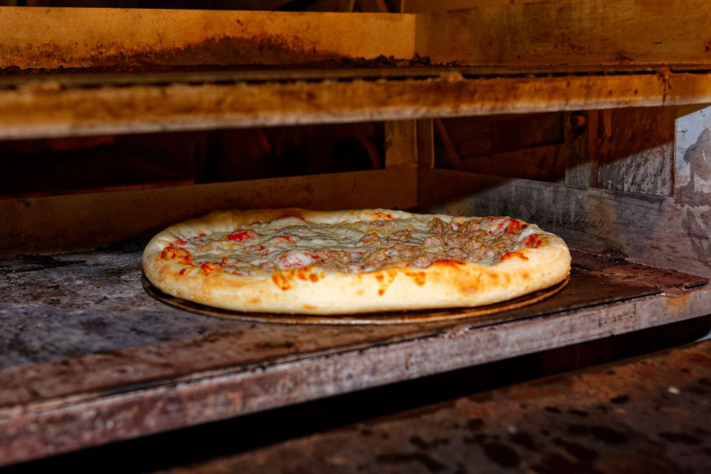 Hot and delicious pizza baking in a traditional stone oven.