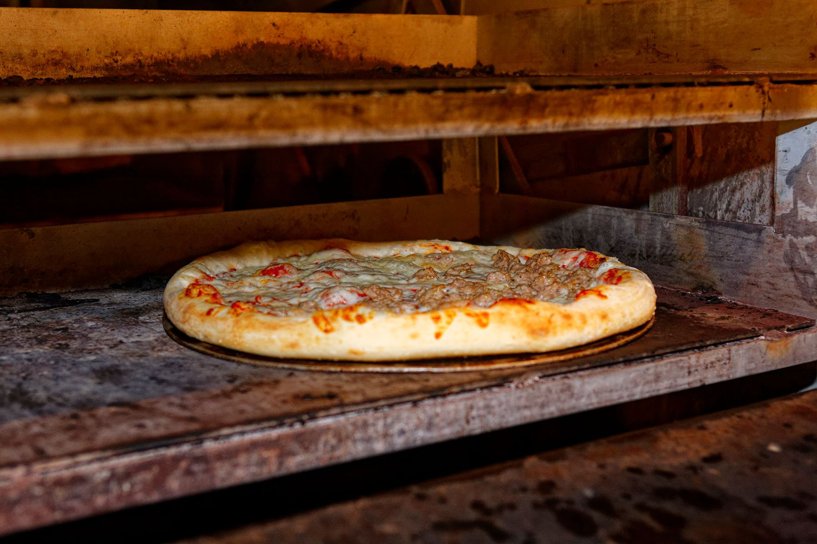 Hot and delicious pizza baking in a traditional stone oven.