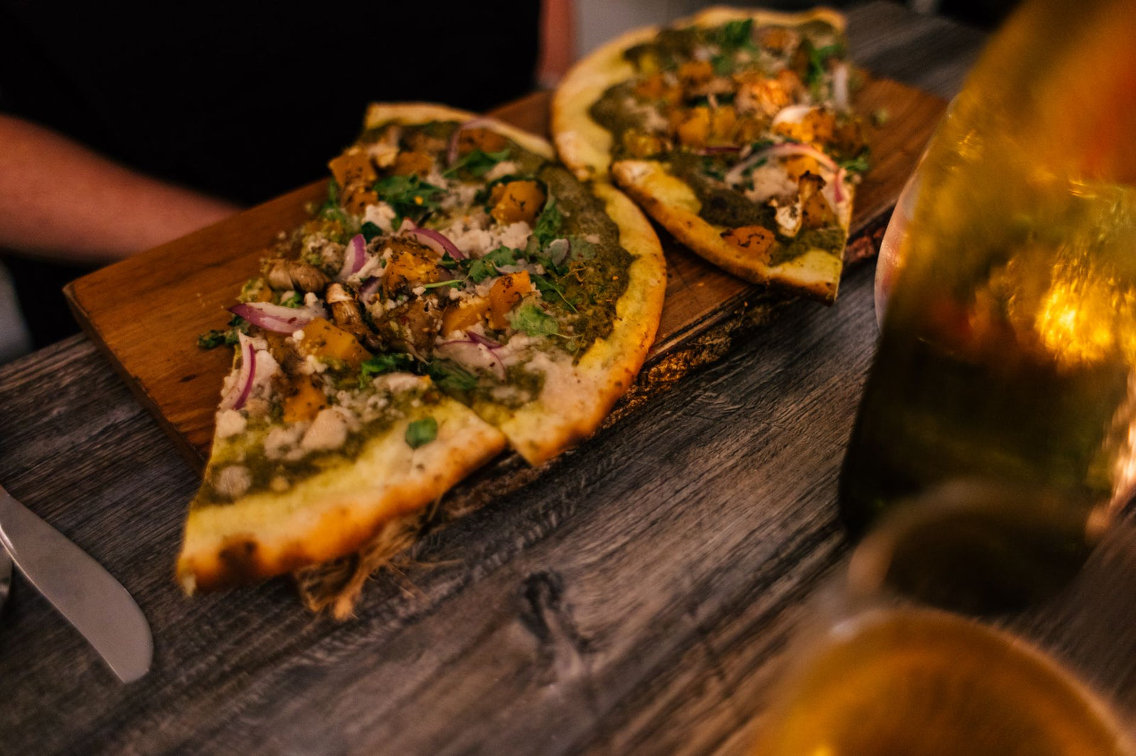 Delicious Italian pizza with gourmet toppings served on a rustic wooden board.