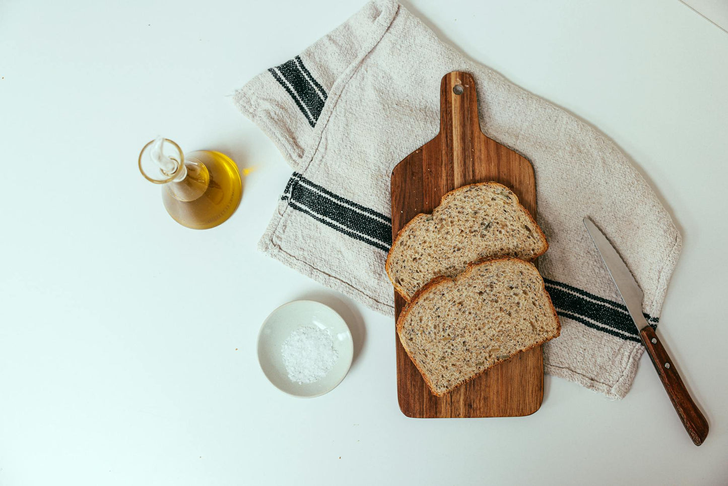 Top view of rustic wheat bread slices on board with olive oil and salt. Perfect for food stock.