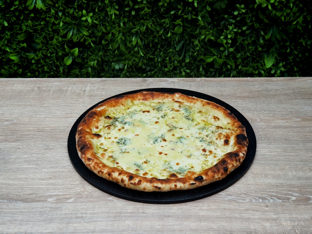 A pizza sitting on top of a wooden table
