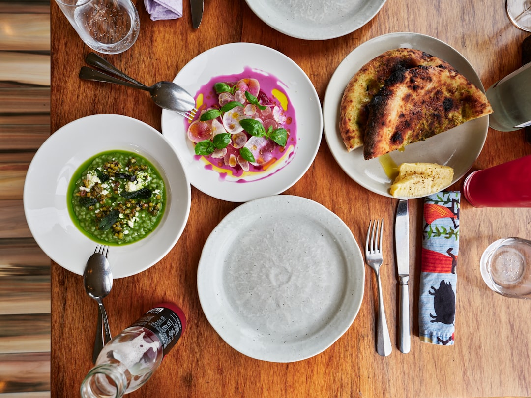 Overhead view of a table set with gourmet dishes.