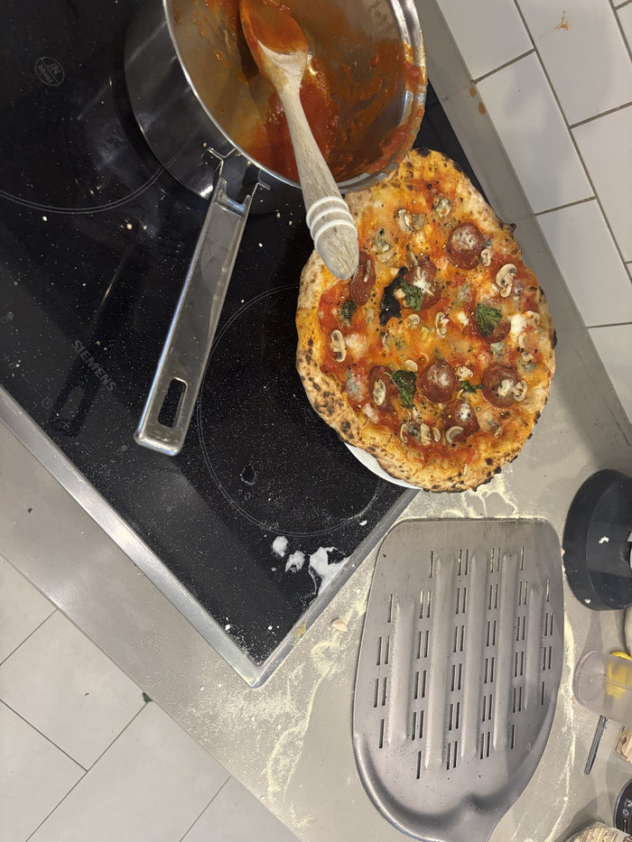 Sauce on the hob and the peel ready, pizza waiting on the counter