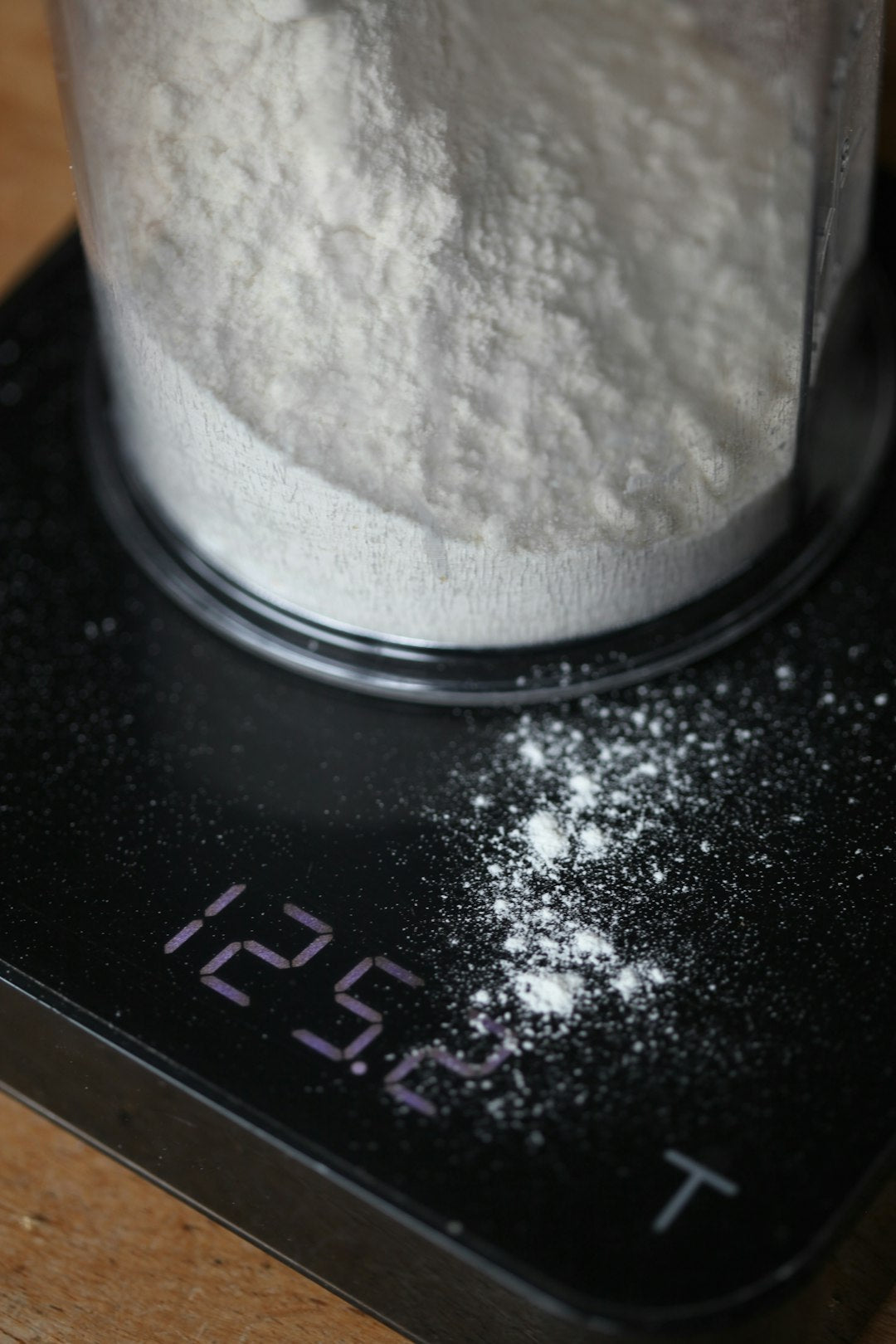 Flour being weighed on a digital kitchen scale — The DoughRise Formula Vault