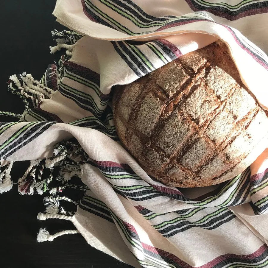 Baked sourdough loaf with a bold cross-hatch wheat crust pattern